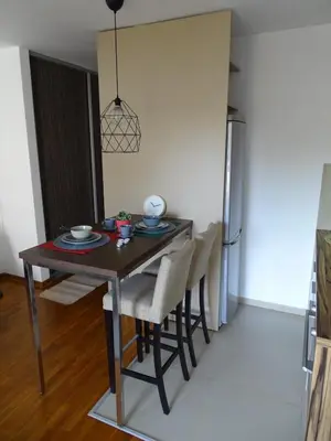 a dining room table and chairs in a room at Blue Apartment in Belgrade