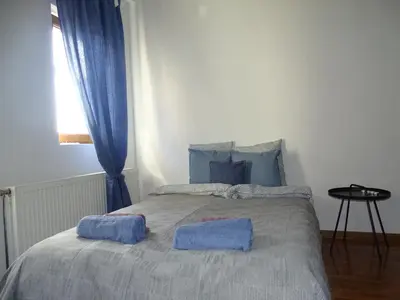 a bedroom with a bed with two towels on it at Blue Apartment in Belgrade