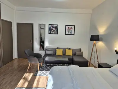 a living room with a bed and a couch at Rooms Villa Luigi in Pančevo