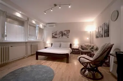 a bedroom with a bed and a chair in it at Ratan in Belgrade