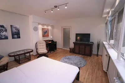 a living room with a table and a television at Ratan in Belgrade