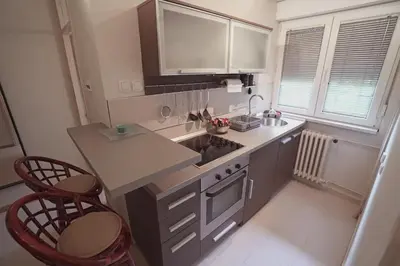 a kitchen with a counter and two chairs in it at Ratan in Belgrade