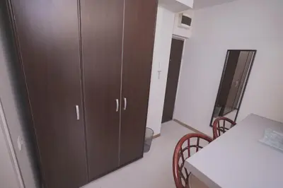 a large brown cabinet in a room with a table at Ratan in Belgrade