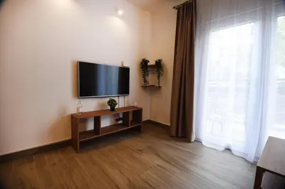 a living room with a flat screen tv on the wall at TASOS in Belgrade