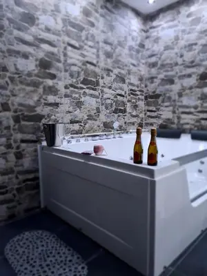 two bottles of beer sitting on a bath tub at TASOS in Belgrade