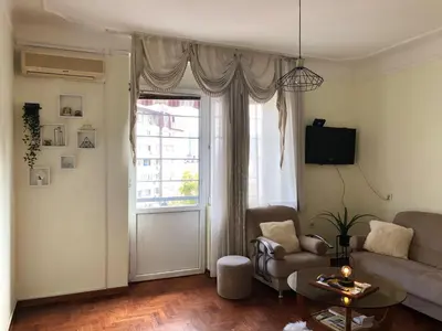 a living room with a couch and a large window at 1BR Flat in Heart Of Belgrade With Panoramic Central View in Belgrade