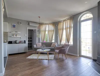 a living room with a couch and a table at Prenociste Dunav 97 K3 in Novi Banovci