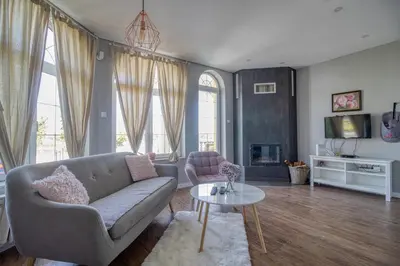 a living room with a couch and a table at Prenociste Dunav 97 K3 in Novi Banovci