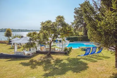 an estate with a swimming pool and a gazebo at Prenociste Dunav 97 K6 in Novi Banovci