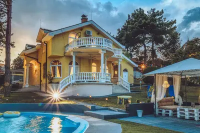 a house with a pool in front of it at Prenociste Dunav 97 K6 in Novi Banovci