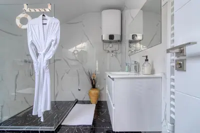 a white bathroom with a shower and a sink at Prenociste Dunav 97 K6 in Novi Banovci