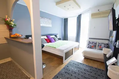 a small room with a bed and a desk in it at Maxim in Belgrade