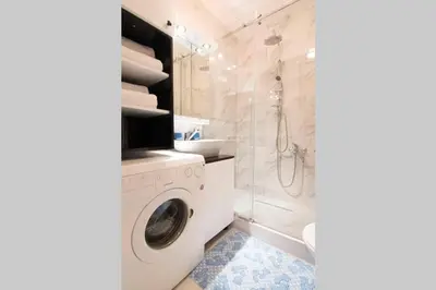 a bathroom with a washing machine and a shower at Maxim in Belgrade