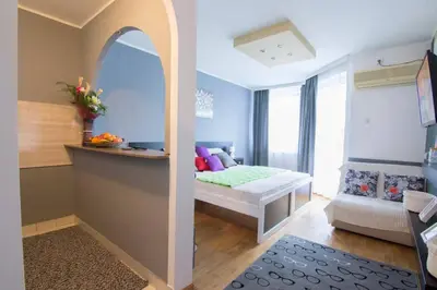 a small room with a bed and a couch at Maxim in Belgrade