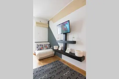 a living room with a television on a wall at Maxim in Belgrade