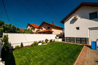 a large white house with a yard at Harmonija na Dunavu in Smederevo