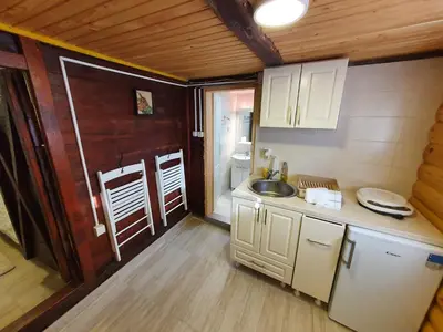 a kitchen with white cabinets and a sink in a room at Vajat Orašac in Arandjelovac