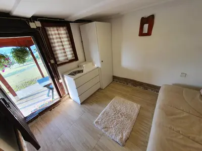 a living room with a couch and a window at Vajat Orašac in Arandjelovac