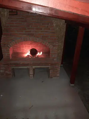 a brick oven with a fire in it at Teja-seosko turističko domaćinstvo in Arandjelovac