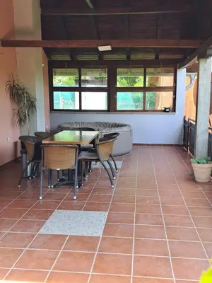 a room with a table and chairs on a tiled floor at Teja-seosko turističko domaćinstvo in Arandjelovac