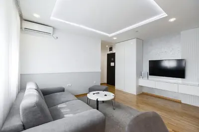 a living room with a couch and a tv at White Apartments in Belgrade
