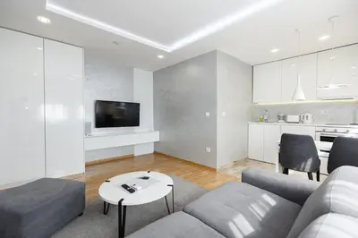 a living room with a couch and a table at White Apartments in Belgrade