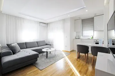a living room with a couch and a table at White Apartments in Belgrade