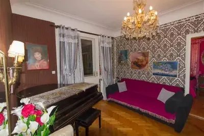 a living room with a purple couch and a chandelier at FABOULOUS apartment in Belgrade