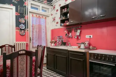 a kitchen with red walls and a counter top at FABOULOUS apartment in Belgrade