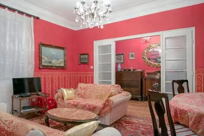a living room with red walls and a couch and a table at FABOULOUS apartment in Belgrade