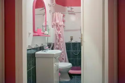 a bathroom with a toilet and a sink and a mirror at FABOULOUS apartment in Belgrade