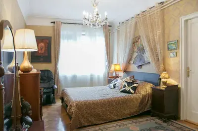 a bedroom with a bed and a chandelier at FABOULOUS apartment in Belgrade