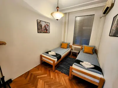 a room with two twin beds and a window at Authentic Belgrade Centre Apartment #3, Four Bedrooms and Two full Bathrooms in Belgrade