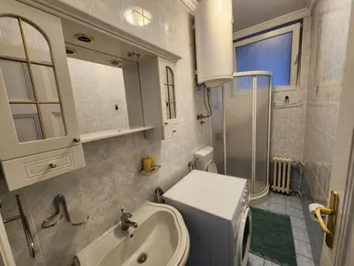a bathroom with a sink and a toilet and a mirror at Authentic Belgrade Centre Apartment #3, Four Bedrooms and Two full Bathrooms in Belgrade