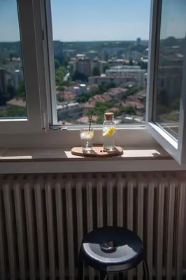 a window sill with a plate and two glasses on it at Sensational view - Zemun in Belgrade