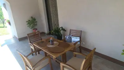 a dining room with a wooden table and chairs at Kosmaj Casa Maia in Dučina