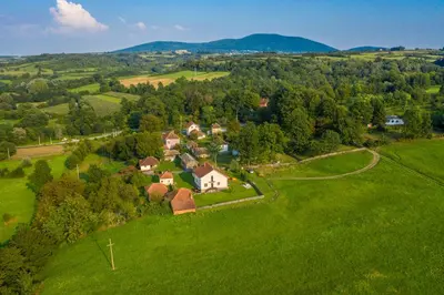 an aerial view of a house in a green field at Kosmaj Casa Maia in Dučina