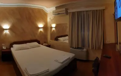a bedroom with a white bed and a window at ESTRADA Lux in Belgrade