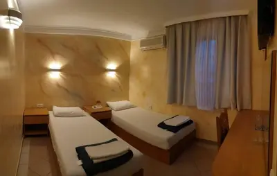 a hotel room with two beds and a window at ESTRADA Lux in Belgrade