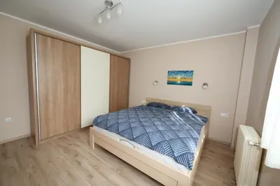 a bedroom with a bed with a blue comforter at Goliath in Belgrade