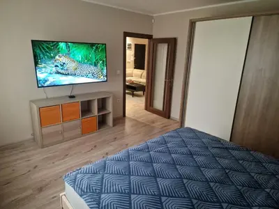 a bedroom with a bed and a flat screen tv at Goliath in Belgrade