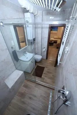 a bathroom with a toilet and a sink and a mirror at Goliath in Belgrade