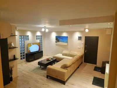 a living room with a couch and a tv at Goliath in Belgrade