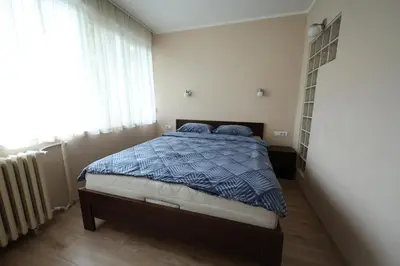 a bedroom with a bed with a blue comforter at Goliath in Belgrade