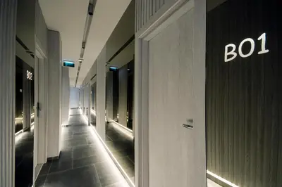 a hallway of a building with a sign on the wall at The Location Hotel in Belgrade