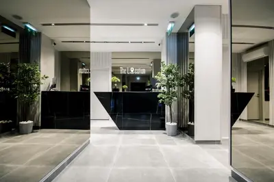 a lobby with potted plants in a building at The Location Hotel in Belgrade