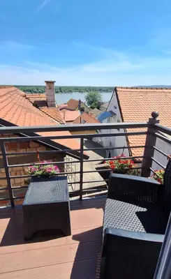 a balcony with benches and flowers on a roof at Villa Tower Gardos in Belgrade