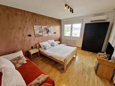 a living room with a couch and a tv at Apartment Nena in Tošin Bunar