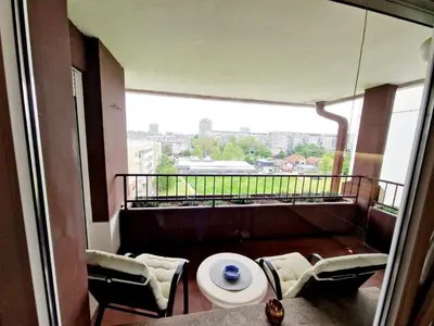 a room with a balcony with a table and chairs at Apartment Nena in Tošin Bunar