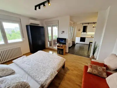 a large room with a bed and a living room at Apartment Nena in Tošin Bunar